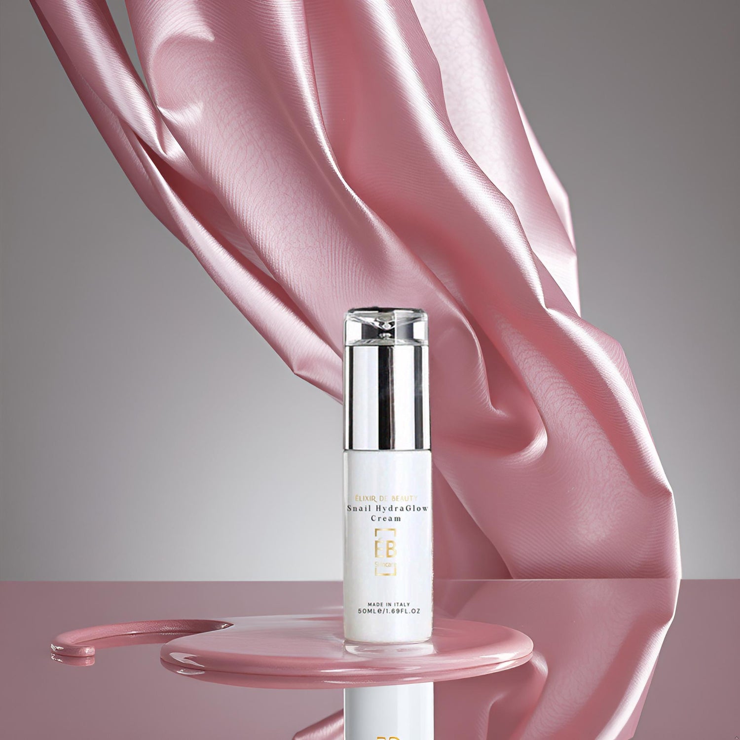 Snail HydraGlow Cream by Élixir de Beauty – hydrating face moisturiser with snail mucin, hyaluronic acid, and Centella, made in Italy – 50ml airless pump bottle with pink silk background